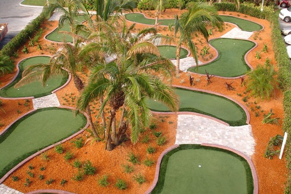 Kennewick Aerial view of a mini golf course with synthetic grass and palm trees.